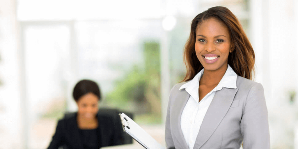 african-american woman employee standing confidently after successfully negotiating a raise